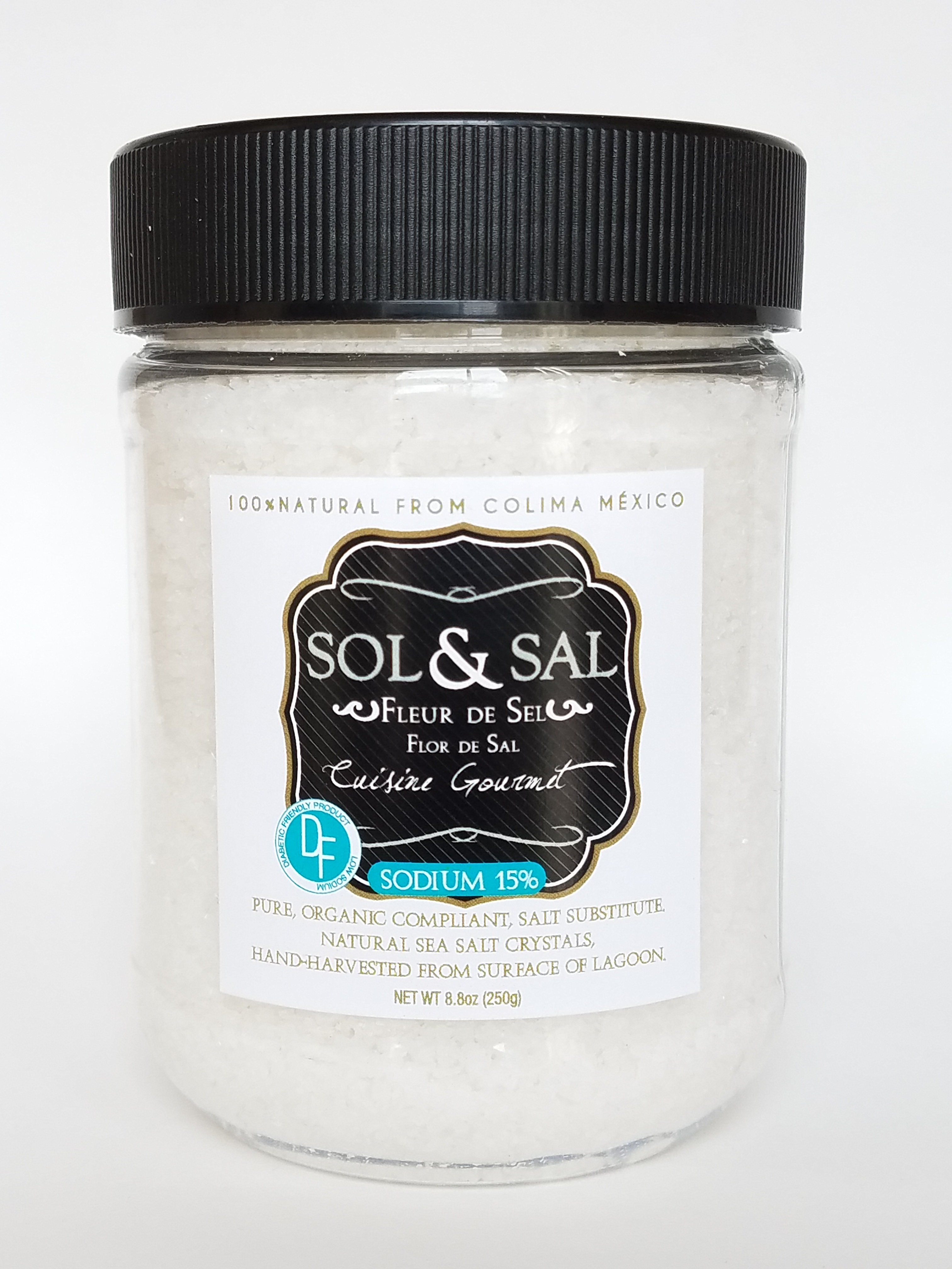 Sol & Sal Fleur De Sel sea salt in an 8oz clear jar with black lid, labeled as organic and hand-harvested from Colima, Mexico.