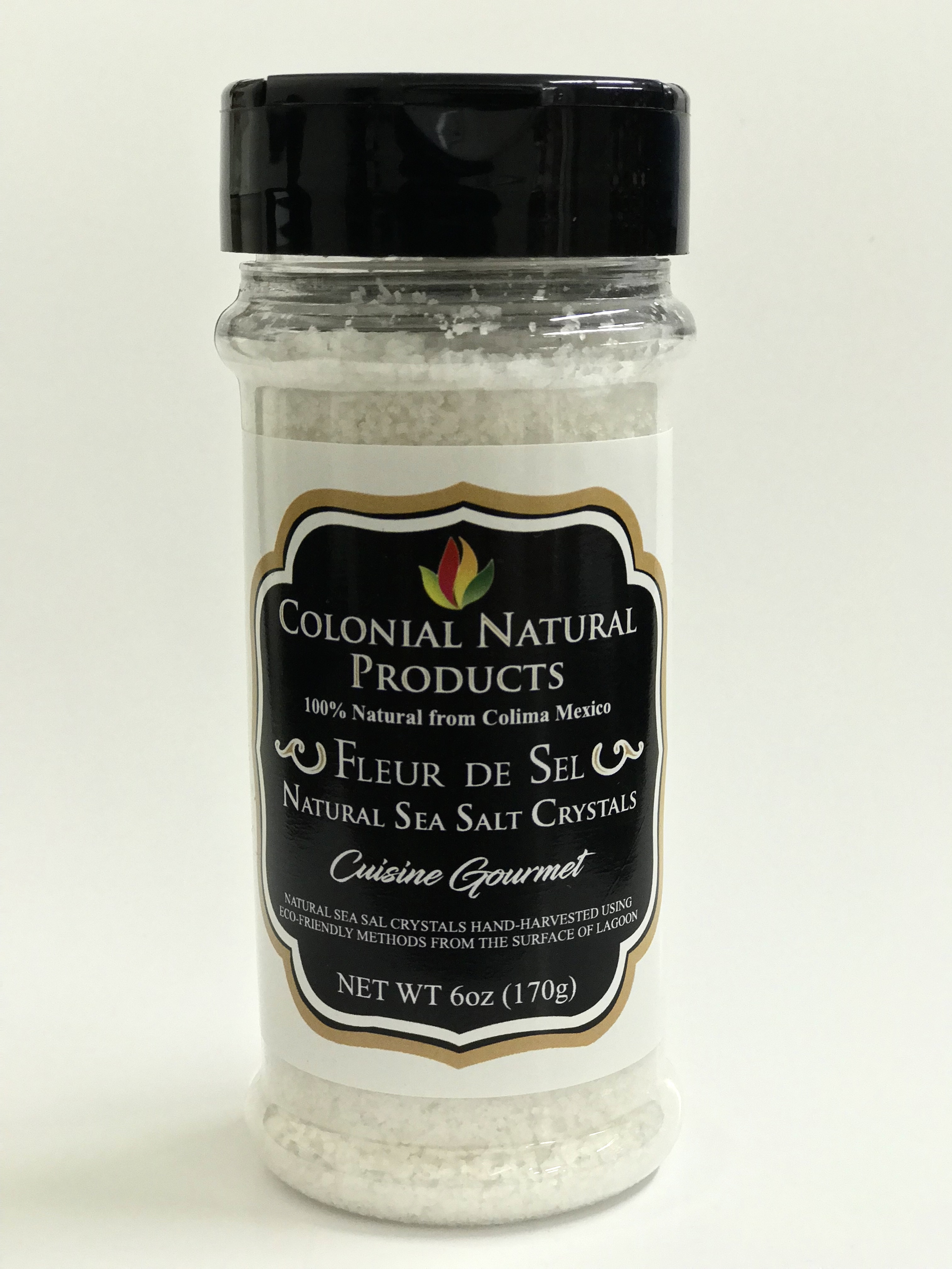 Fleur De Sel Salt by Colonial Natural Products in a 6oz bottle, featuring natural sea salt crystals from Colima, Mexico for gourmet cooking.